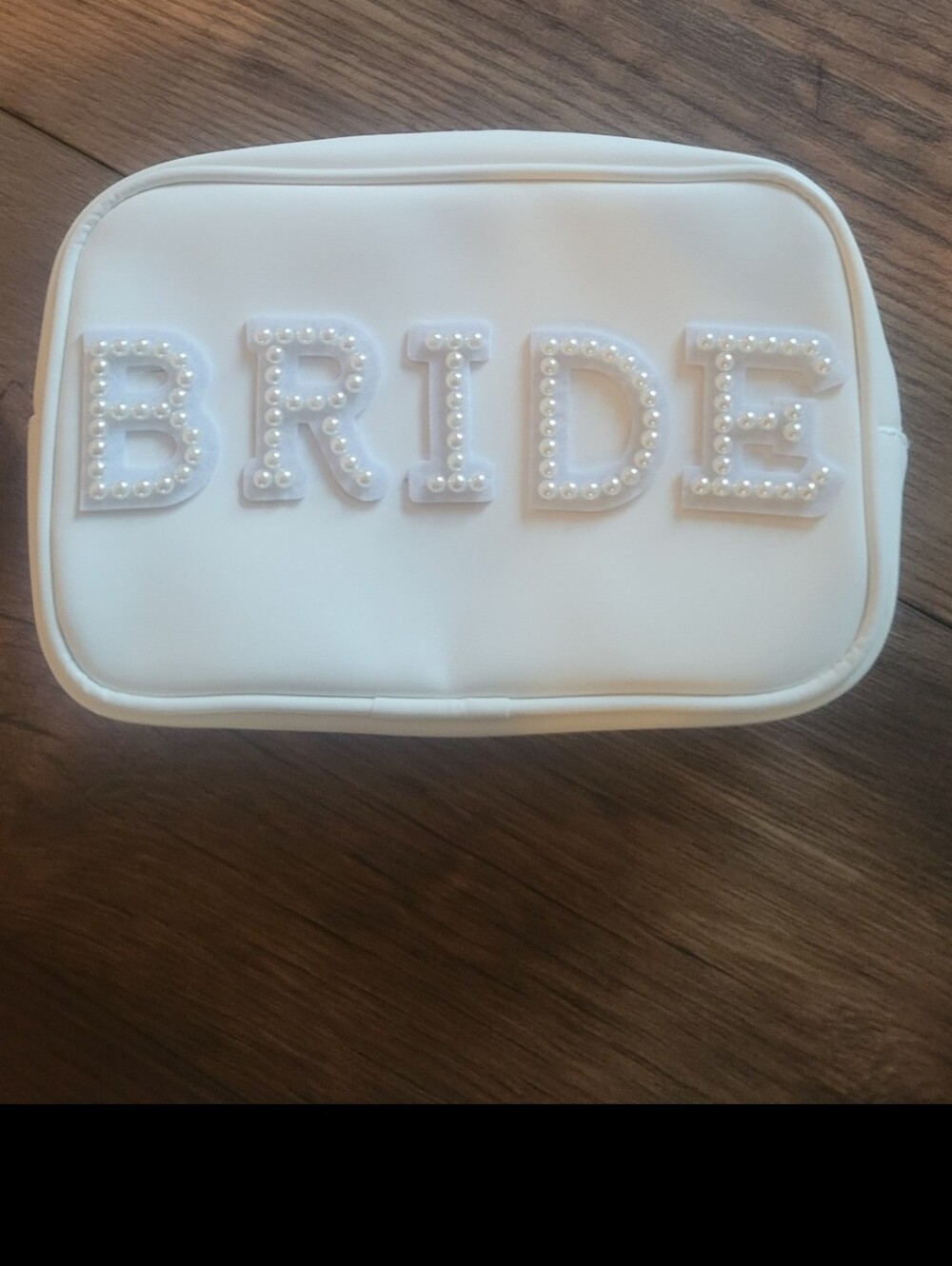 Cosmetic zip pouch featuring the word "BRIDE" spelled Out With Pearl Accents